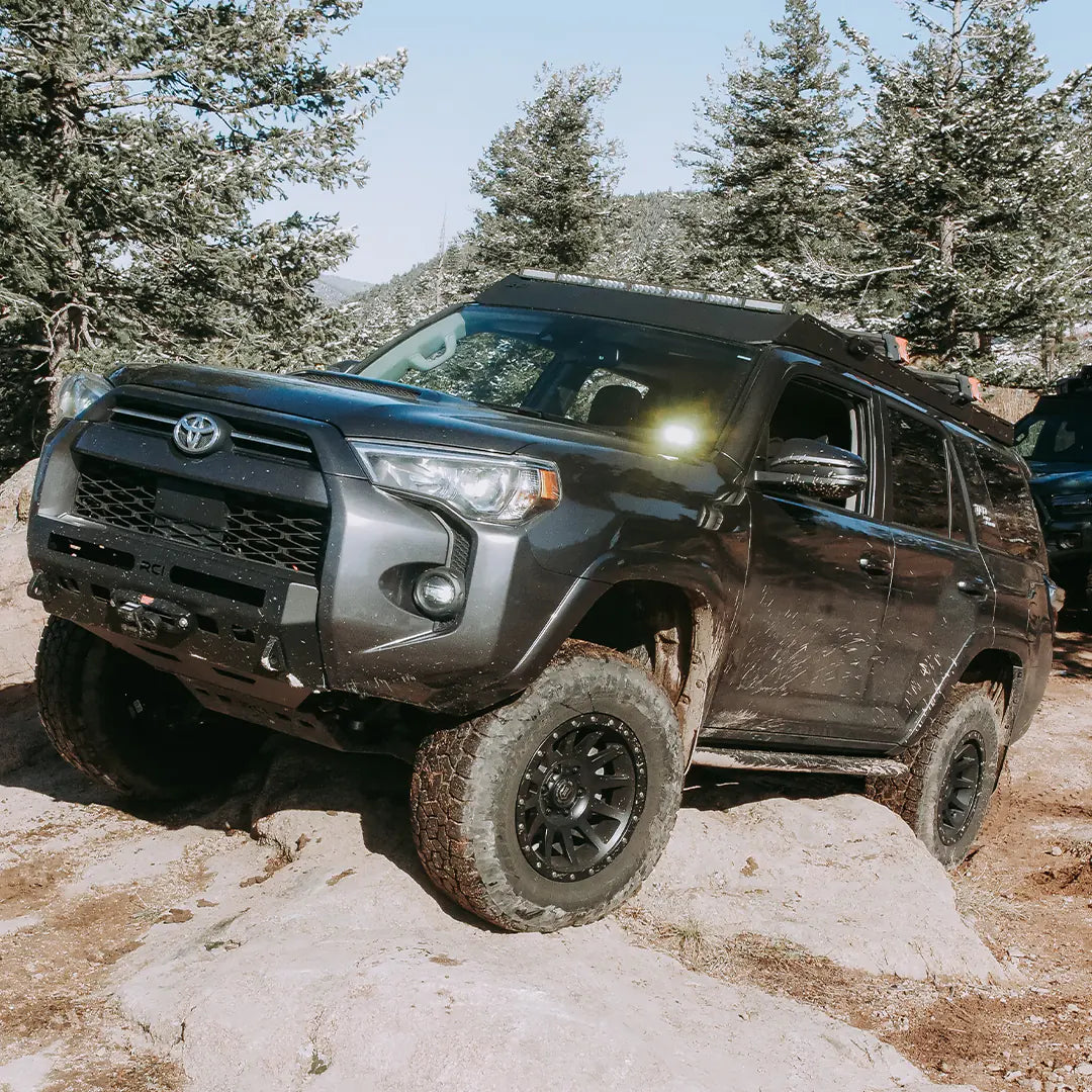 4runner roof rack with mud on a rock