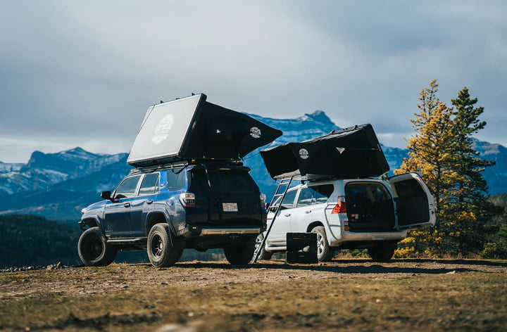 View of the roof top tent with 2 vehicles and 2 tents