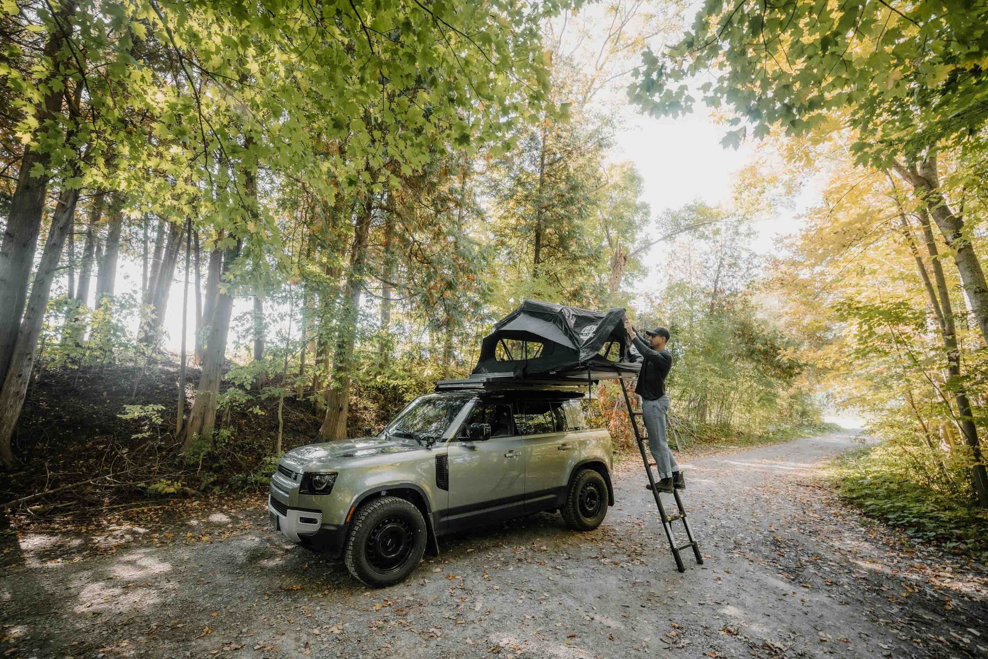 Large view of the hybrid roof top tent with the ladder in the forest