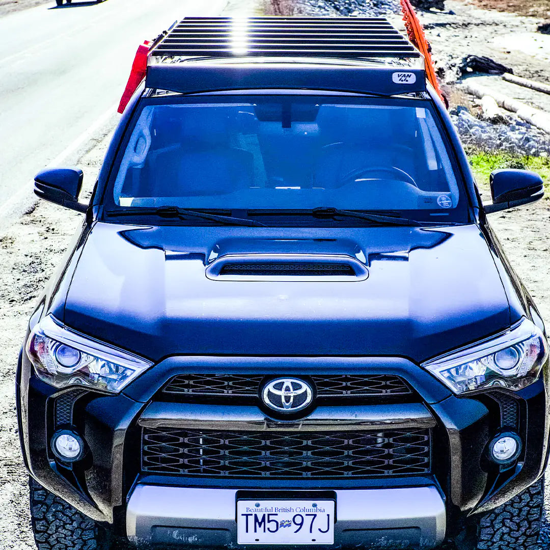 Front view of this beautiful Toyota 4runner with a traction board and a roof rack system