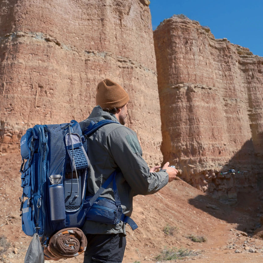 Backpack with power station, powering drone