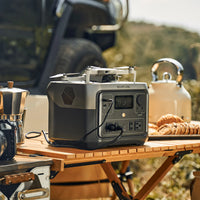 View of the power bank with ac outlet charging a drone in camping