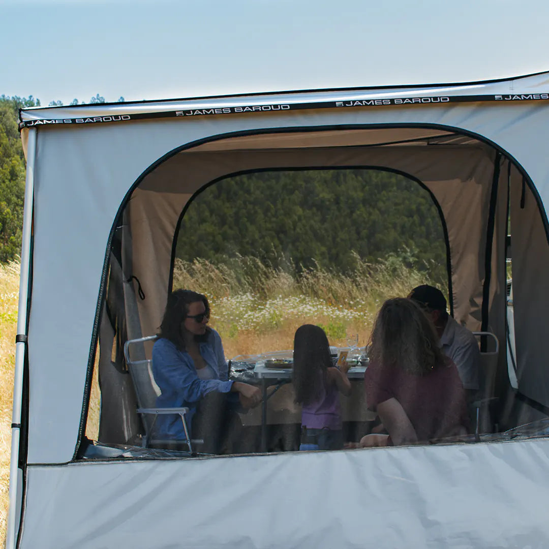 Side view of the Family Room with a family inside and a mosquito net