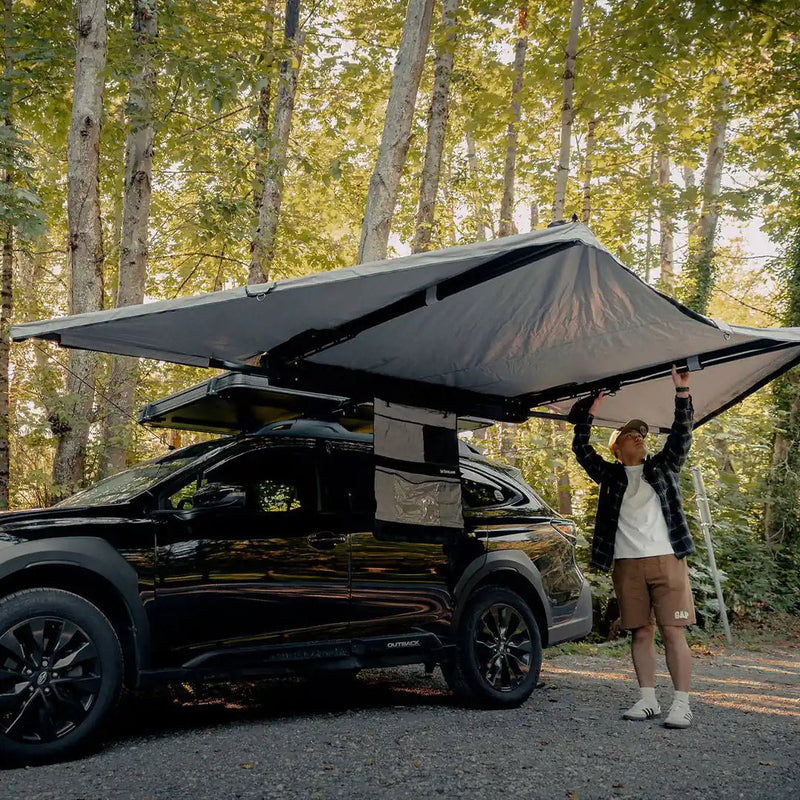 Self Standing Awning on a little car with a man under it