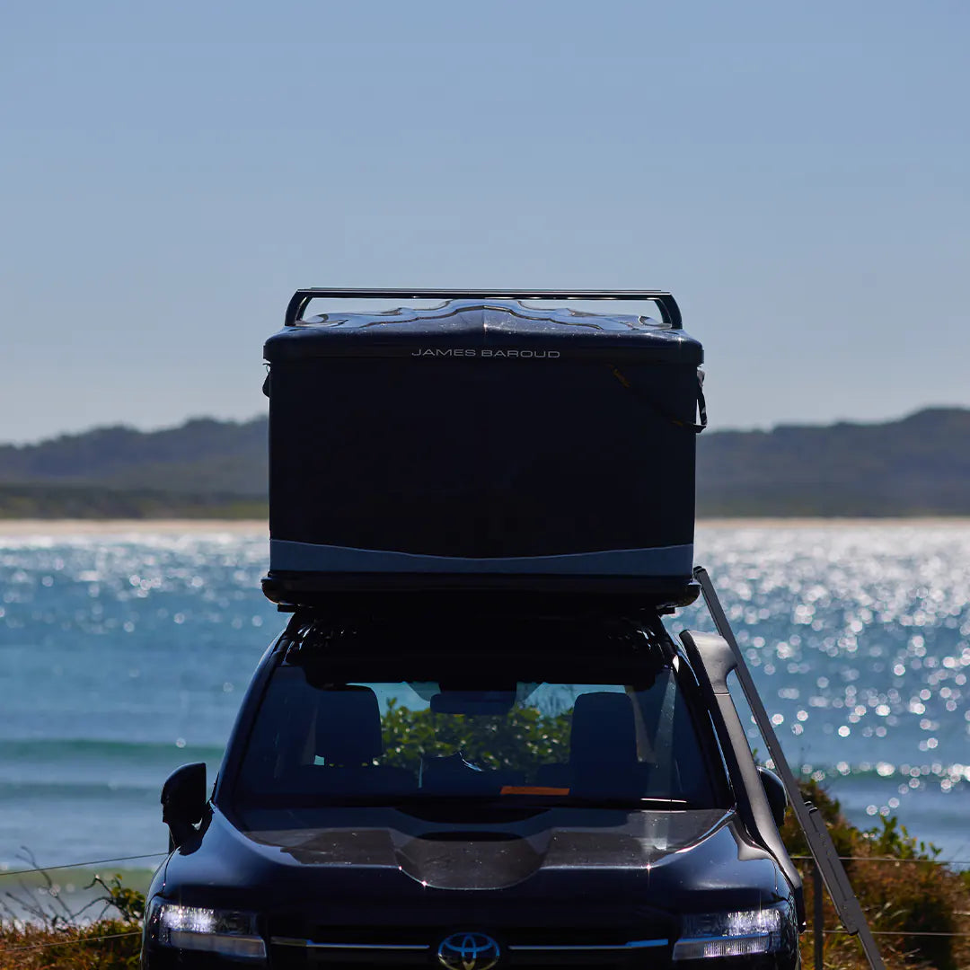 Front view of the rooftop tent crossbars on a odyssey with water background