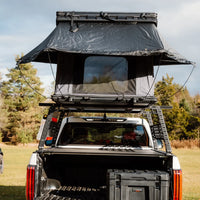 Rear view opened of the large roof top tent with sun and integrated awning