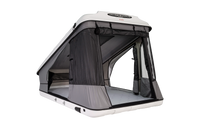 Clamshell Roof top tent with windows and doors open with view of the mattress