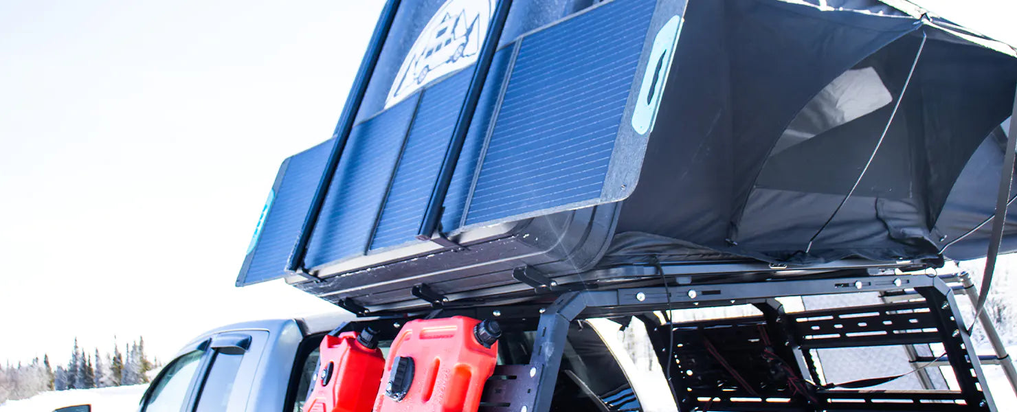Portable Solar Panel on a roof top tent during winter with snow background