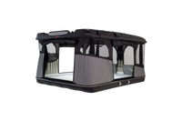 Side view of the James Baroud Grand Raid Pop up Roof Top Tent with lights on