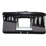 Side view of the black roof top tent with lights on and windows open