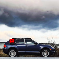 Large view of the Porsche Cayenne with Rotopax gas can on the side and lake background
