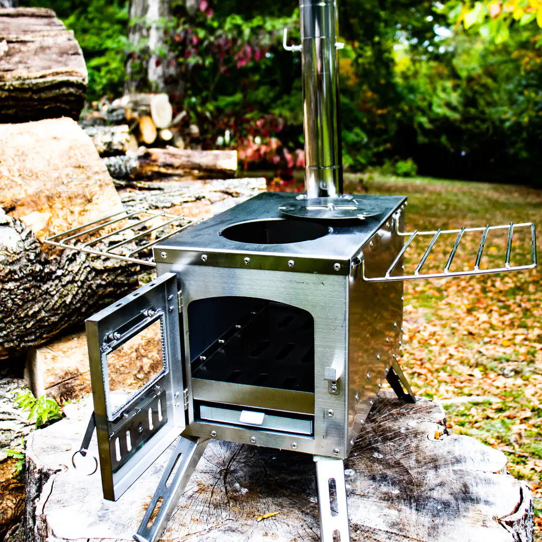 View of the portable camping wood stove with top and door open