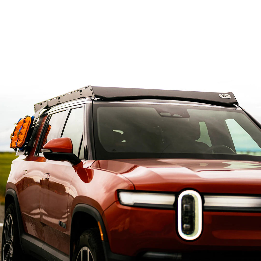 Large view of the overland setup with traction boards, roof rack and molle organizer on the rivian