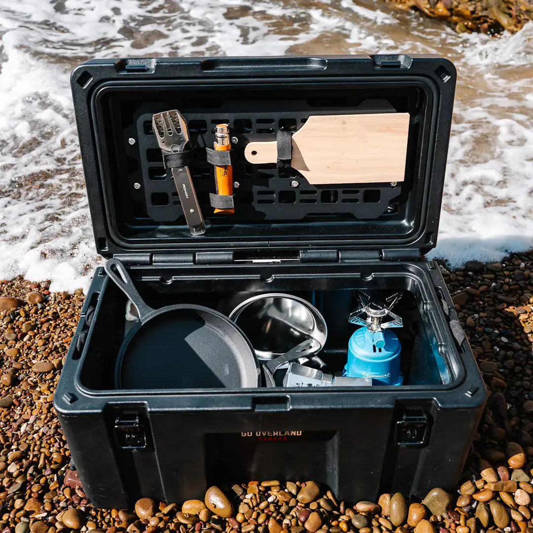 All stuff in the rugged case on sand on the sea