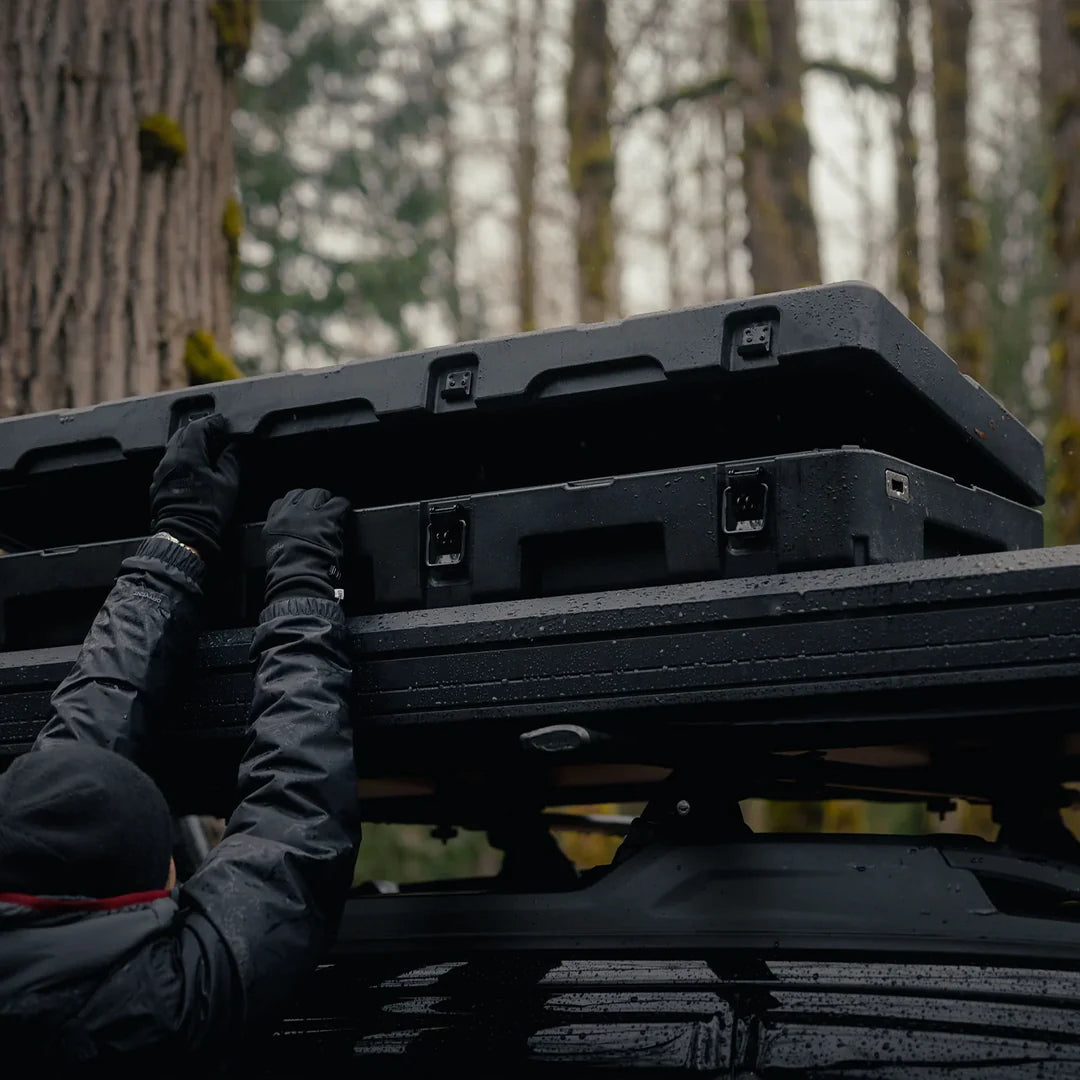 Opening the rugged case on the roof of the roof top tent on a car