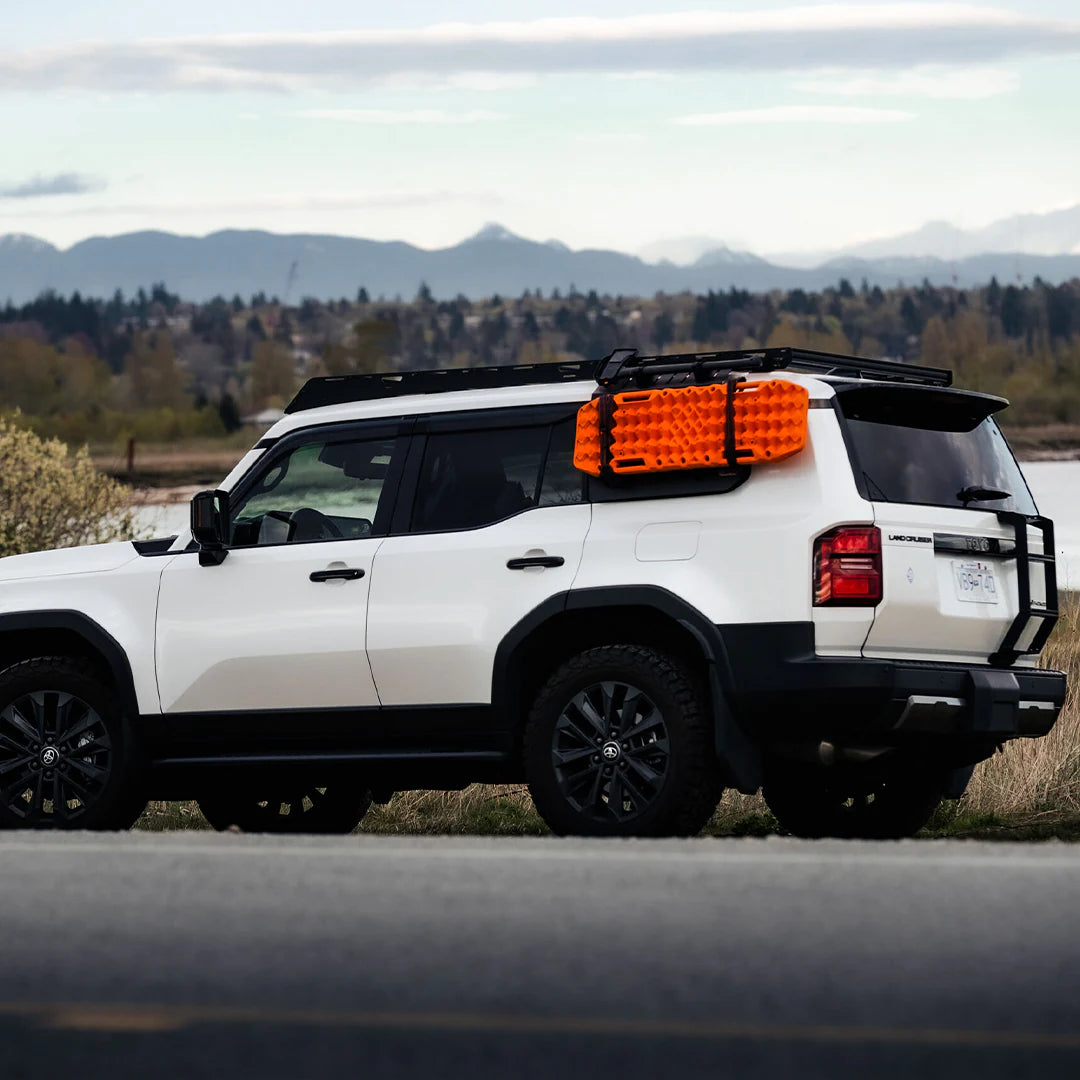 Side view of the land cruiser roof rack with rear ladder and traction boards
